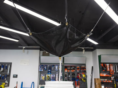 Black ceiling leak diverter in use catching a roof leak into a bucket (100 x 100cm)