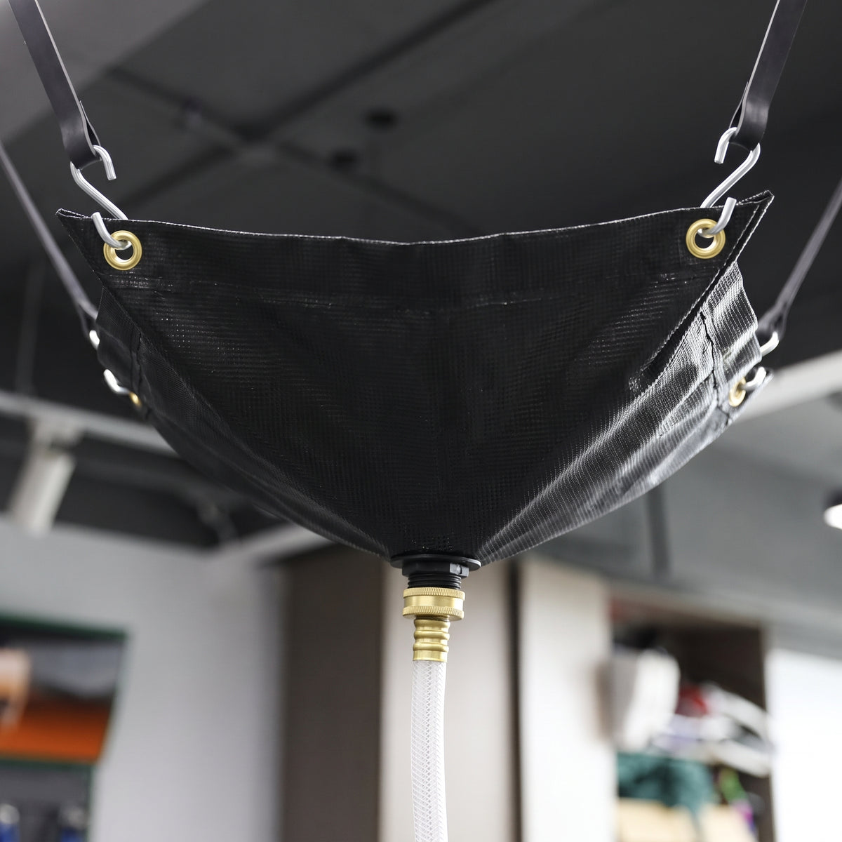 Black ceiling leak diverter hose outlet connection close-up (91 x 305cm)