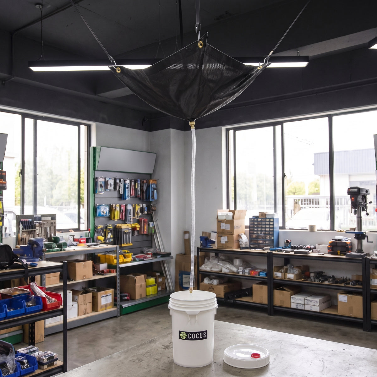 Black ceiling leak diverter kit in use, hose draining into a COCUS bucket (152 x 305cm)