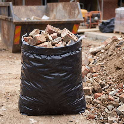 Heavy duty black rubble sack filled with bricks and rubble on a construction site