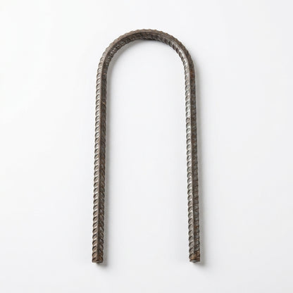 A U-shaped piece of twisted rebar wire with a textured metallic finish, displayed vertically on a clean white background.