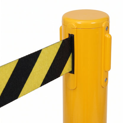 Close-up of a yellow retractable belt barrier post with a black and yellow striped fabric strap extending from the side, shown on a white background.