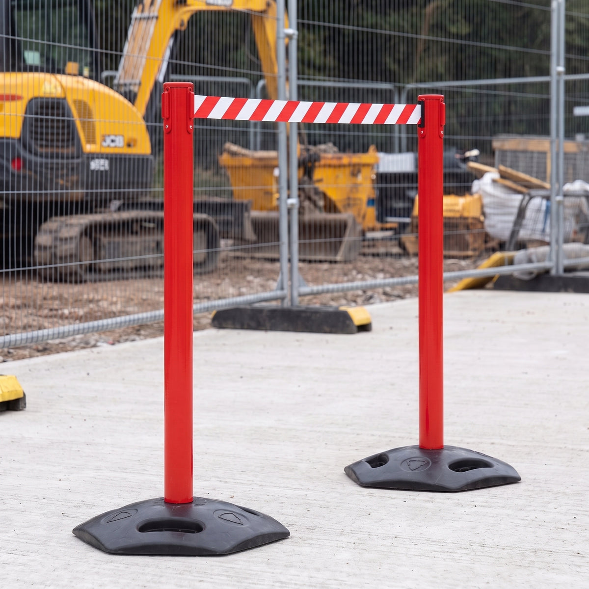 Red retractable belt barriers cordoning off an area on a construction site (WRH959)
