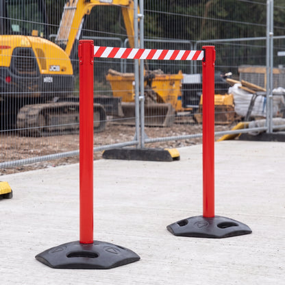 Red retractable belt barriers cordoning off an area on a construction site (WRH959)