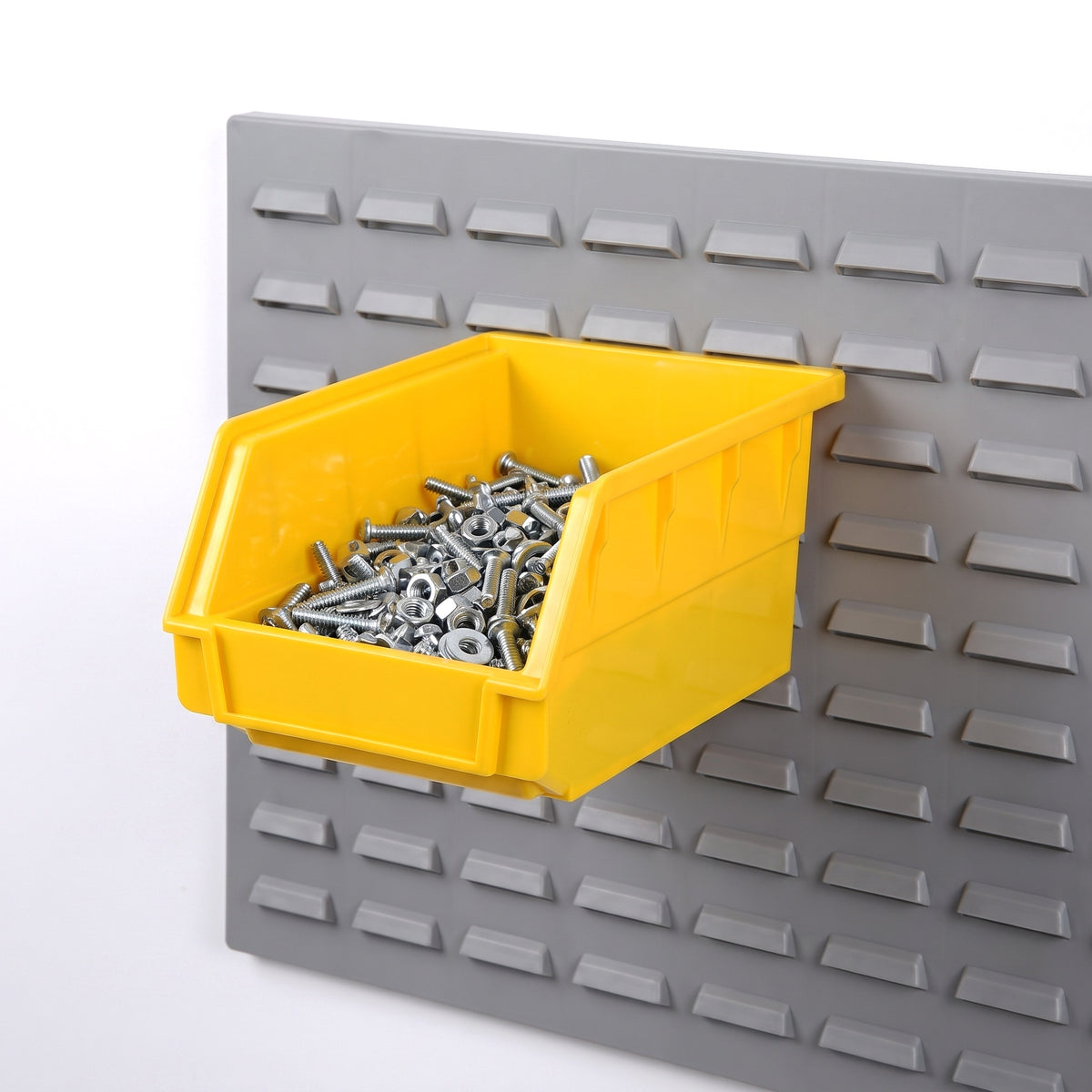Small yellow hook-on bin on a louvre panel filled with fixings