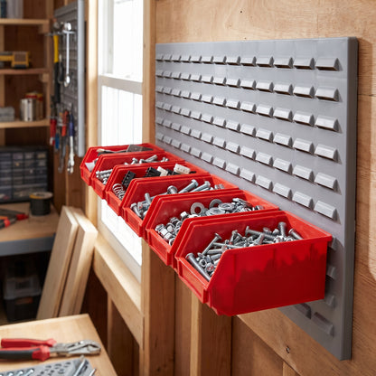 Row of medium red hook-on bins on a louvre panel in a workshop